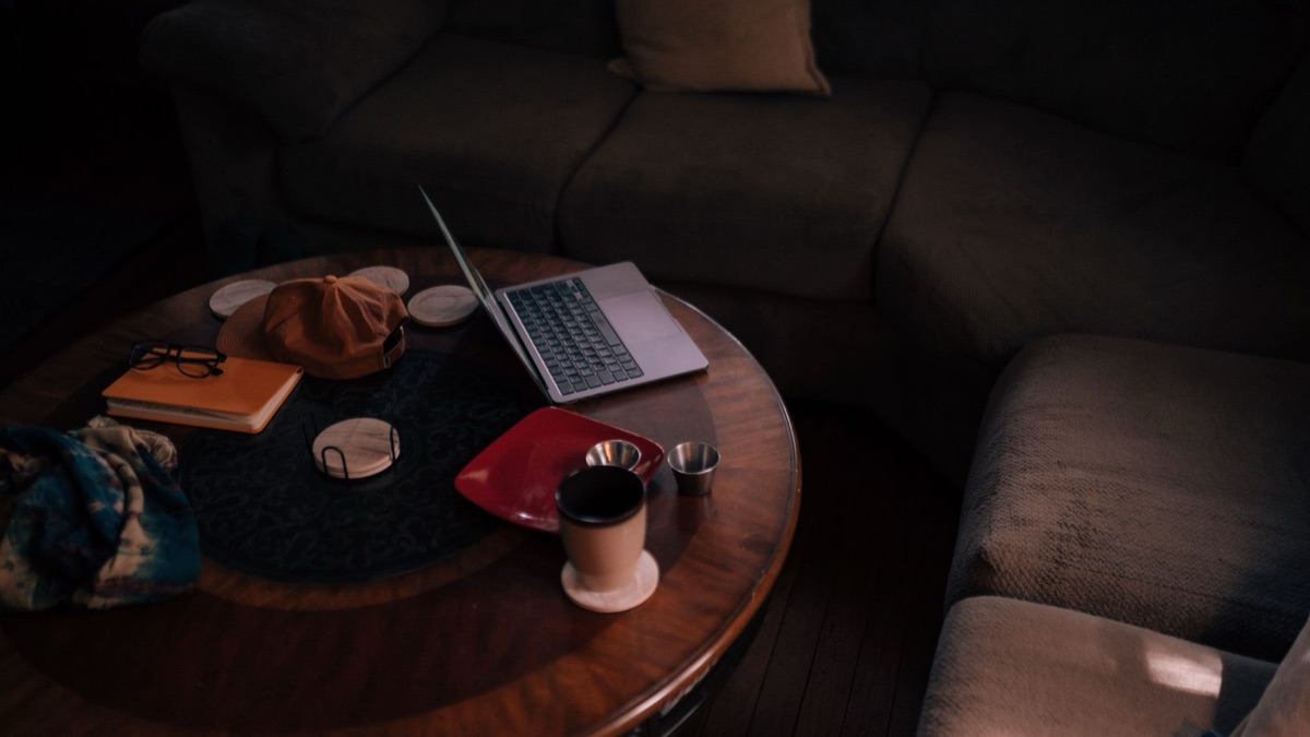wireless router placed on a coffee table in a living room with a bookshelf in the background